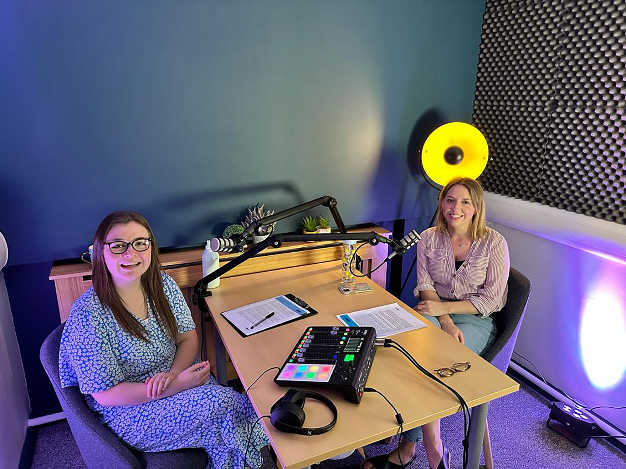 2 girls chatting while doing a podcast