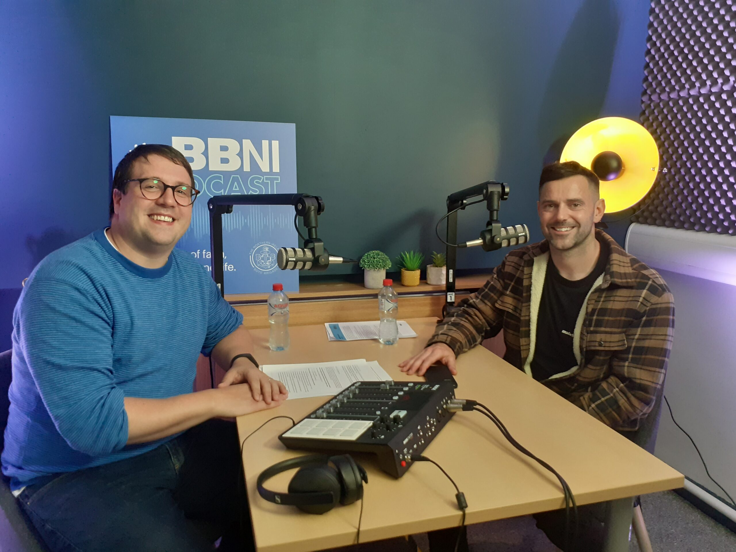 2 men sitting in a podcast studio, one from BBNI, and one from Made For More