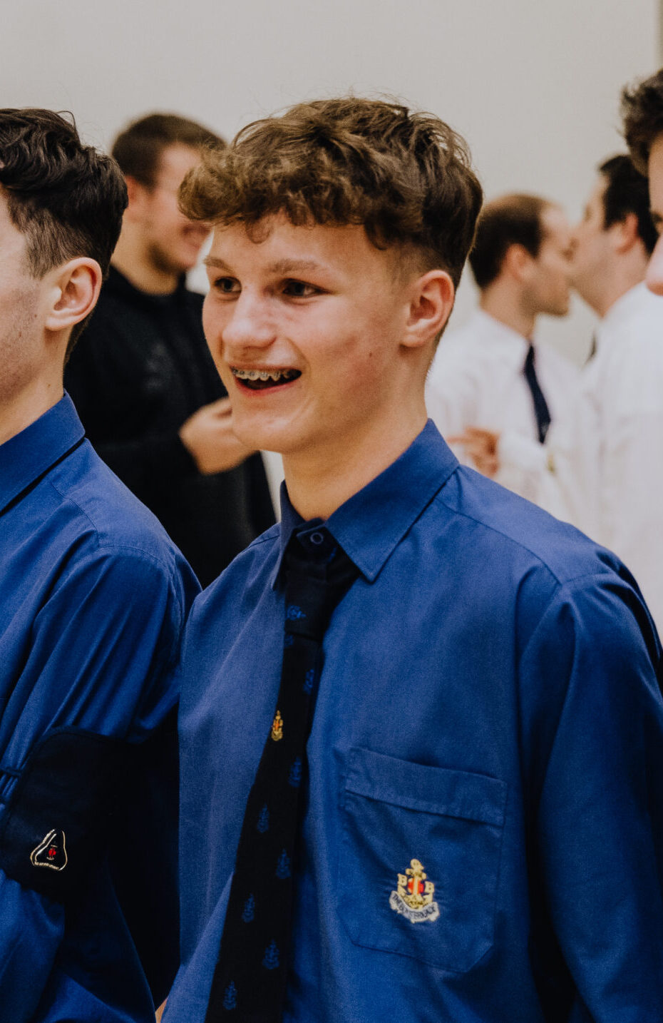 3 teenage boys in bb uniform smiling