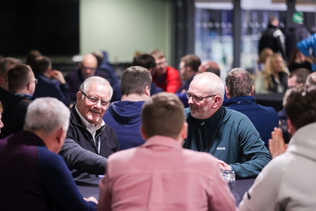 leaders at a thank you event, eating food at a table