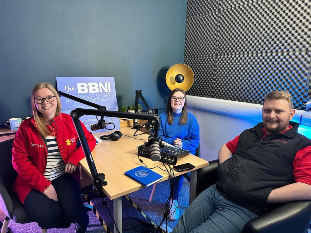 3 people sitting at a desk, about to record a podcast, Children's Heartbeat Trust